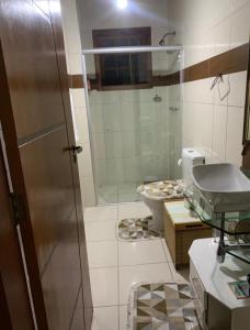 a bathroom with a glass shower and a toilet at 3 Pinheiros in Campos do Jordão