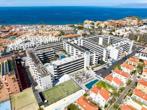 an aerial view of a city with buildings and the ocean at HOVIMA Suites Costa Adeje in Adeje