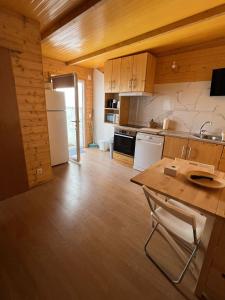 a kitchen with wooden cabinets and a wooden floor at Casa da Praia in Carvalhal