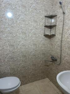 a bathroom with a toilet and a sink at centrhouse in K'obulet'i +21 photos