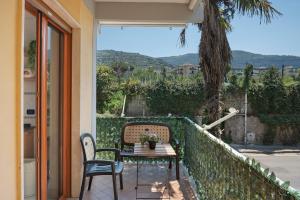 a table and chairs sitting on a balcony with a view at Sorrento Beach And Center House in Sorrento