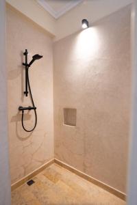 a bathroom with a shower in a wall at Villa Daïs - Marrakech in Marrakech