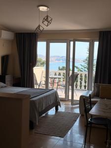 a bedroom with a bed and a view of the ocean at Imperia in Bar