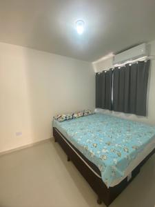 a small bedroom with a bed and a window at Lar caminho da Ilha in Igarassu