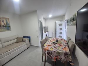 a living room with a table and a couch at Mare e Luna in Lastva