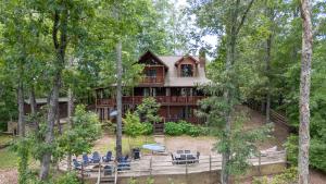 ein großes Holzhaus mitten im Wald in der Unterkunft Whippoorwill Calling - Panoramic Mineral Bluff Cabin - Panoramic Views, Hot Tub, Nature Trail, Private Cul-De-Sac Home, Firepit, in Mineral Bluff