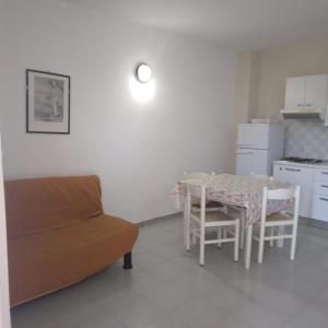 a living room with a table and a couch at Residence Poseidon Villaggio in Isola Capo Rizzuto