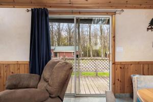 a couch in a living room with a sliding glass door at Vacation Home Rental PM 51 in Russell