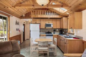 a kitchen with a table and a white refrigerator at Vacation Home Rental PM 51 in Russell