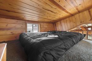 a bedroom with a bed in a wooden cabin at Vacation Home Rental PM 51 in Russell +7 photos