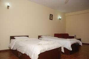 Postel nebo postele na pokoji v ubytování Kathmandu Madhuban Guest House