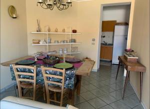 a kitchen with a table with chairs and a refrigerator at Nonna Maria B&B Home restaurant in La Marinella