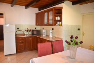 a kitchen with a vase of flowers on a table at Haus Pelso in Gyenesdiás