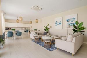 a living room with a couch and a table at Luxury 3 BR Apartment with Terrace, pool & gym in Mijas Costa