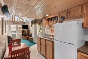 a kitchen with a refrigerator and a dining room at Vacation Home Rental PM C-06 in Russell