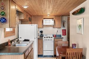 a kitchen with a white refrigerator and a sink at Vacation Home Rental PM C-06 in Russell