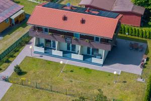 an overhead view of a house with a red roof at Apartamentai Trys pušys in Šventoji