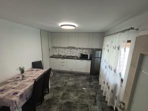 a dining room with a table and a kitchen at Colț de lavandă in Braşov +9 photos