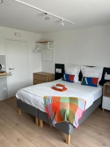 a bedroom with a bed with a rainbow blanket on it at Business Accommodation 'Urban Living' Intimate in Geel