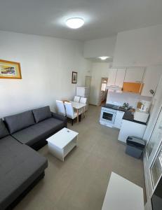 a living room with a couch and a table at Apartments Marta - Zadar - near the sea in Zadar