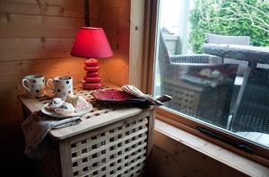 a red lamp sitting on a table next to a window at Lodge with HotTub-Garden-PetsOK-Bbq-MountainViews in Brecon