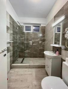 a bathroom with a shower and a toilet and a sink at Seashore retreat in Mamaia Nord