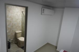 a bathroom with a toilet and a shower at Hotel Gama Cartagena in Cartagena de Indias