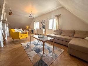 a living room with a couch and a table at Appartement cosy à deux pas de la cathédrale in Chartres