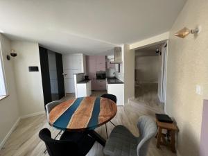 a kitchen and dining room with a table and chairs at Le Castelnau in Les Sables-dʼOlonne