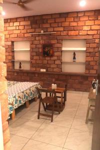 a room with two benches and a brick wall at Mordhwaj in Jodhpur