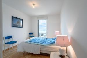 a white bedroom with a bed and a window at Les voiles du large in Les Sables-dʼOlonne +19 photos