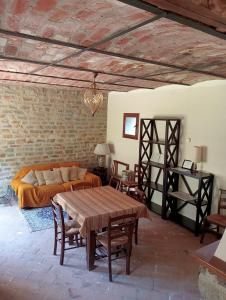 a living room with a bed and a table at Villa Chiaromonte in Vesime +5 photos