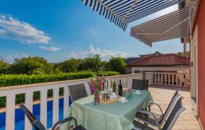 a table and chairs on a balcony with a view at Villa Bilanzic - Omis by Villas Guide in Kreševo