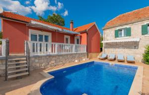 a swimming pool in front of a house at Villa Bilanzic - Omis by Villas Guide in Kreševo
