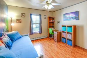 a living room with a blue couch and a desk at Family Retreat 2 Mi to Santas House Pets Welcome in North Pole