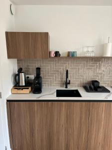 a kitchen with a sink and a counter top at Business Accommodation 'Natural Living' Nomad in Geel