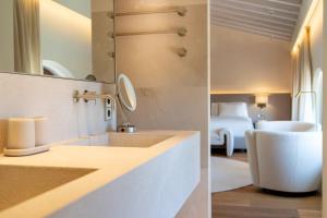 two pictures of a bathroom with a sink and a bedroom at Finca Banyols, Vignette Collection by IHG in Alaró +61 photos