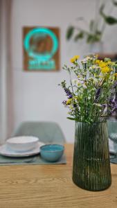 a vase filled with flowers sitting on a table at METIS Apartment in Martin