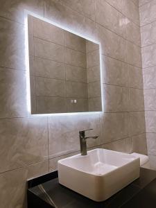 MamaDe Marii Hotel FZE的浴室里有一面镜子的白色水槽