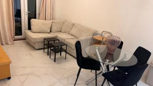 a living room with a couch and a glass table at comfy residence in Moffat