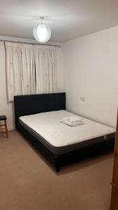 a bedroom with a bed in front of a window at comfy residence in Moffat
