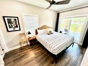 a bedroom with a bed and a window at Hip Gruene Condo, Walk to Gruene Hall, On River! in New Braunfels +9 photos
