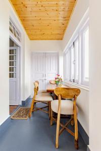 a dining room with a table and two chairs at Calissa Cottage 2BHK Mall Road in Mussoorie