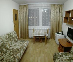 a living room with a couch and a table at Willa BIM in Rewal