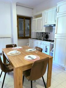 a kitchen with a wooden table with wine glasses on it at Cielo Aperto Bed and Breakfast in Rome