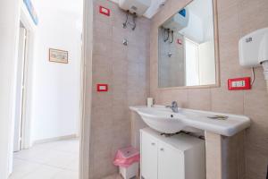 a bathroom with a sink and a mirror at Jerà Suite Vista Mare 19 in Lipari +11 photos