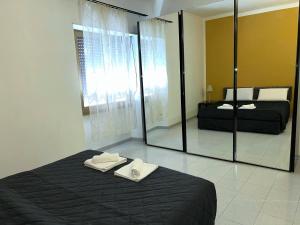 a bedroom with a bed and a large mirror at Cielo Aperto Bed and Breakfast in Rome