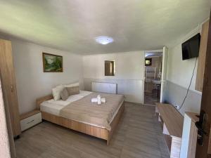a bedroom with a bed with two candles on it at Anita Vendégház Korond in Ascio +4 photos