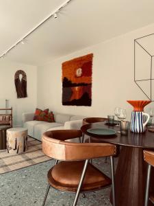 a living room with a table and a couch at DUNE, Maison Littoral by BLOSS stylish apartment with garden and terrace in De Haan