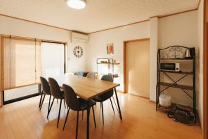 a dining room with a wooden table and chairs at 野波一棟貸古民家  +28 photos